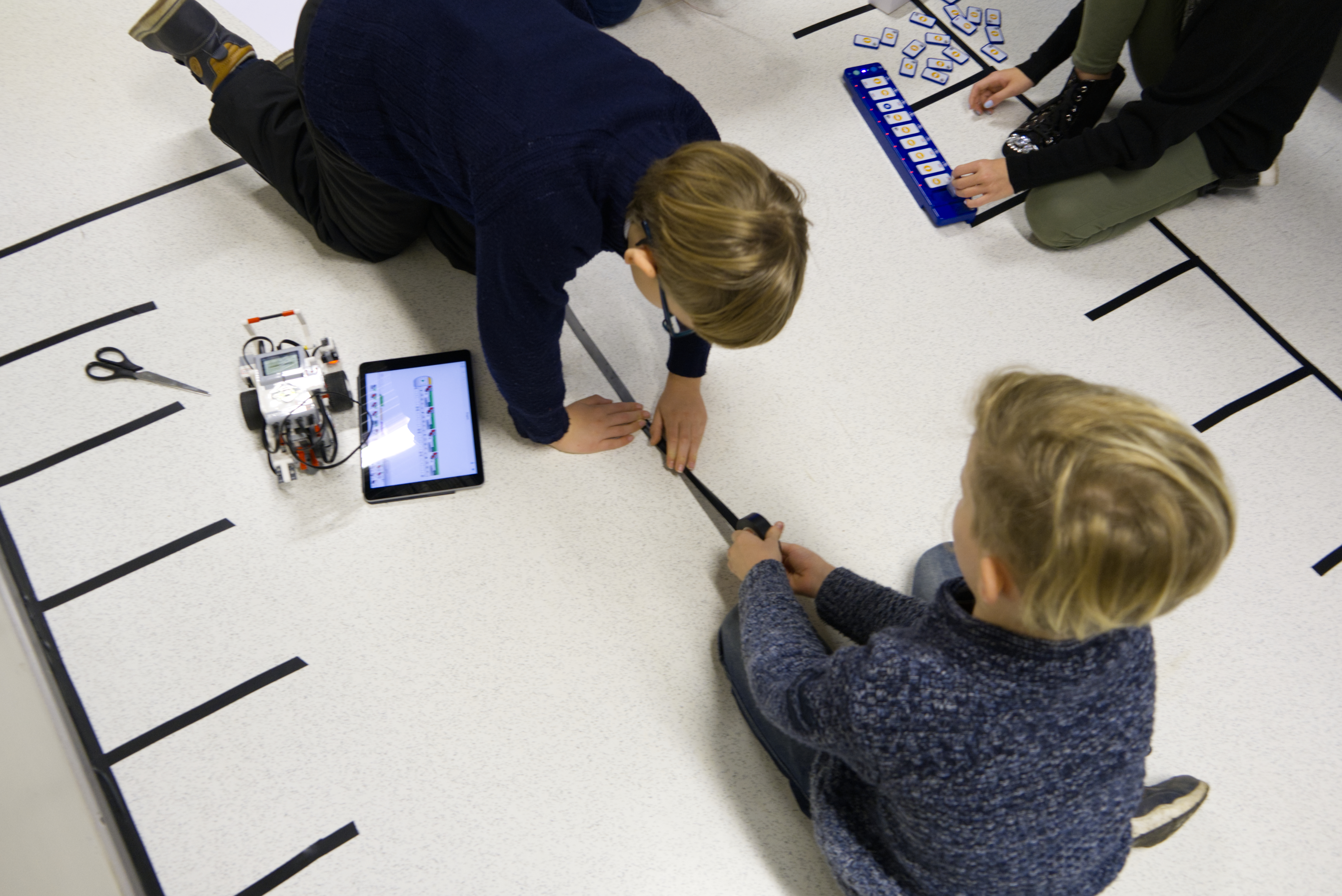Students teaching parking rules to self-driving robot car.