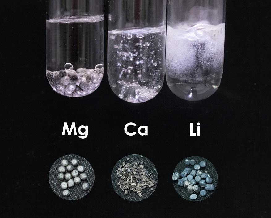 Photo: Magnesium (Mg), calcium (Ca), and lithium (Li) as solids and in water: Lithium is a rare alkali metal essential for Li-ion batteries, while calcium offers a sustainable alternative to this scarce element. However, both lithium and calcium are incompatible with water, yet their reactions are less vigorous compared to sodium. In contrast, magnesium reacts very slowly, ensuring safe handling. Its abundance and cost-effectiveness make this lightweight metal popular as a construction material in everyday products. Author:Marharyta Laktsevich-Iskryk