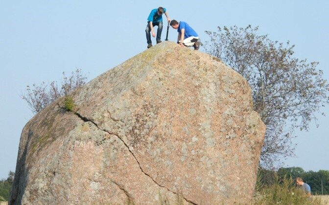 Scientists taking samples from an erratic.